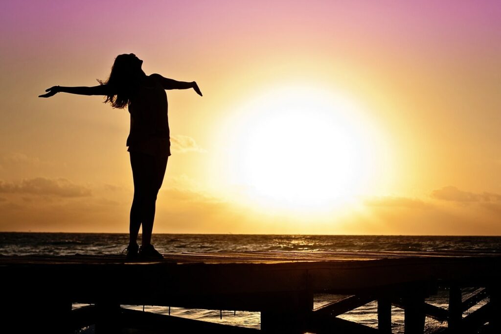 Solar Panel Installers Colchester | Woman Embracing Dawn