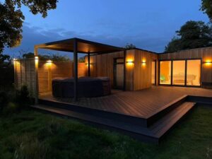 Modern energy efficient homes made of wood lit up with lights at night