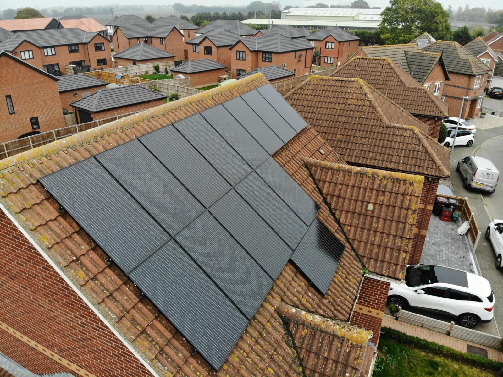 Domestic solar panel installers complete solar panel project on roof of brick home