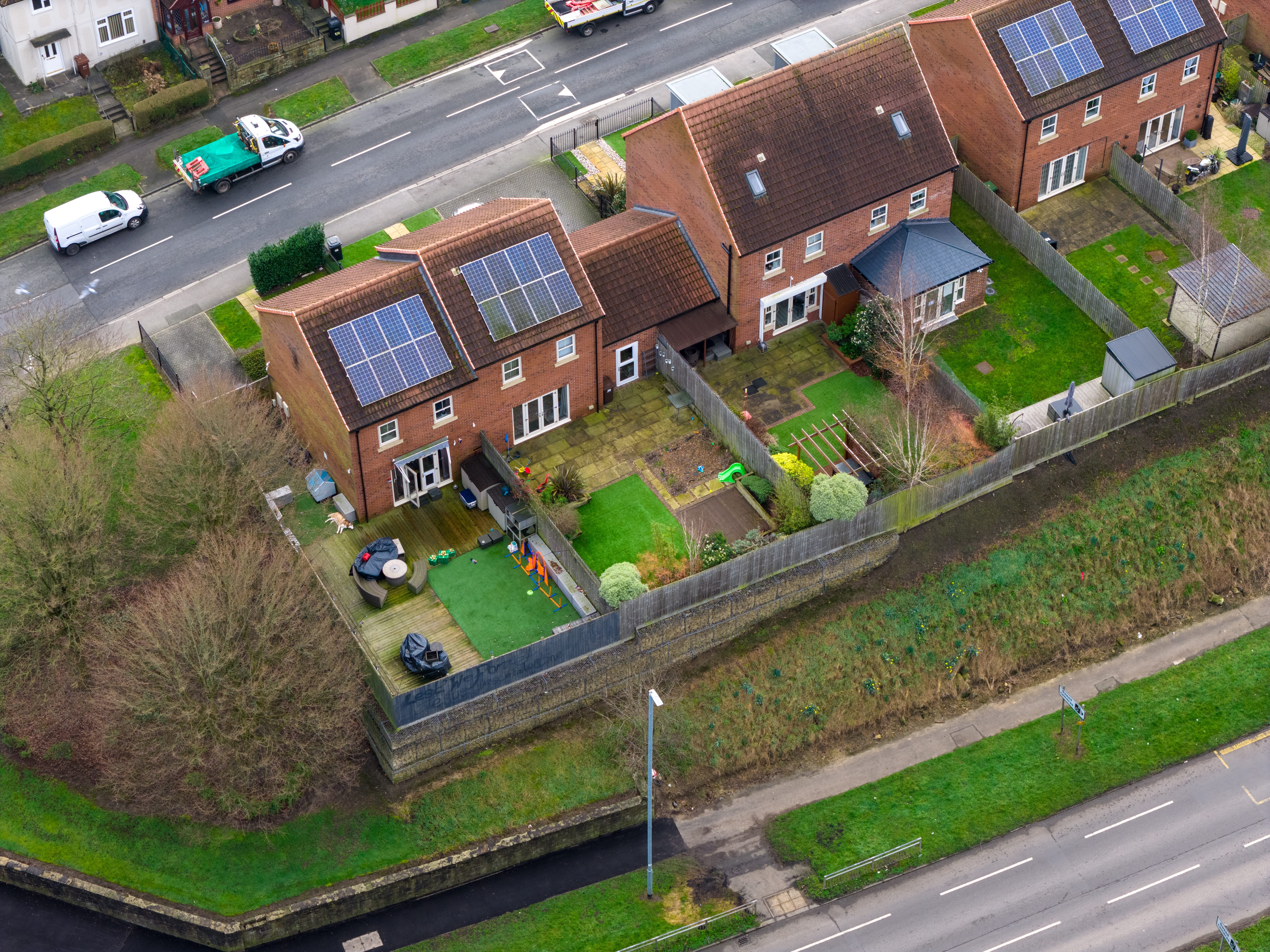 Overhead shot of brick houses with solar panels for are home solar panels worth it blog