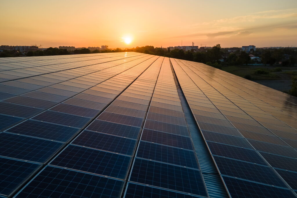 Large roof at sunset after commercial solar panel installation in Essex