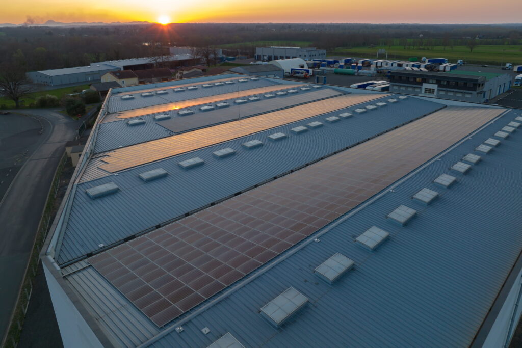 Overhead shot of industrial unit at sunset with commercial solar battery storage installed