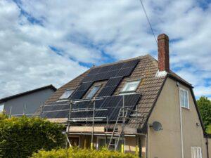Cost of solar panel installation demonstrated by house having solar installed