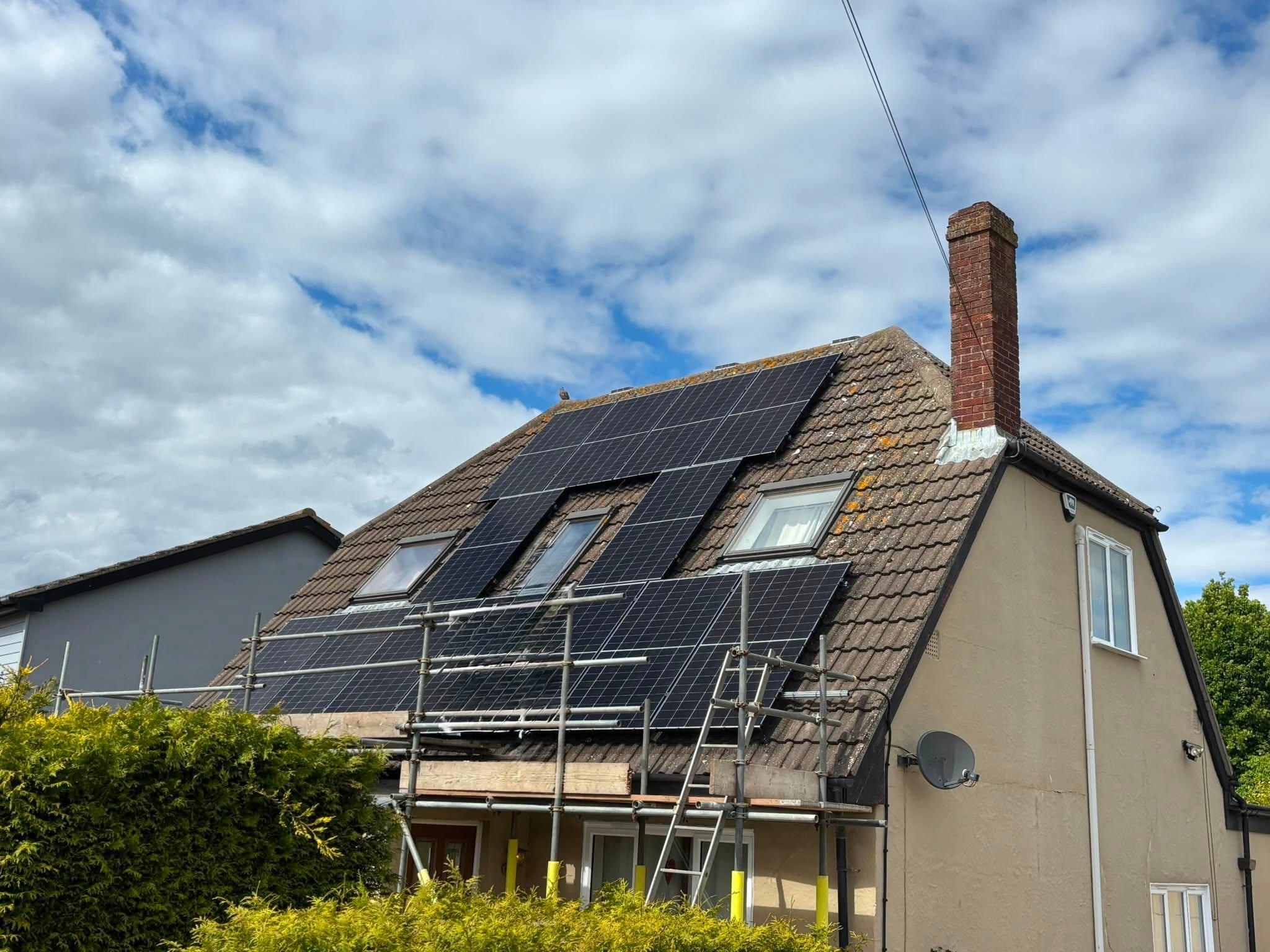 Cost of solar panel installation demonstrated by house having solar installed